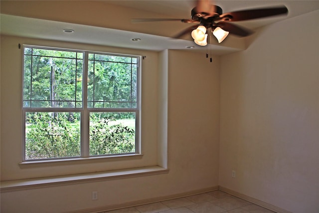 empty room with baseboards and light tile patterned floors