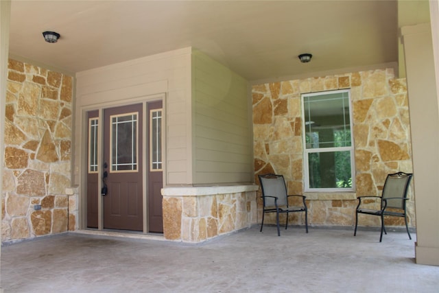 property entrance with stone siding