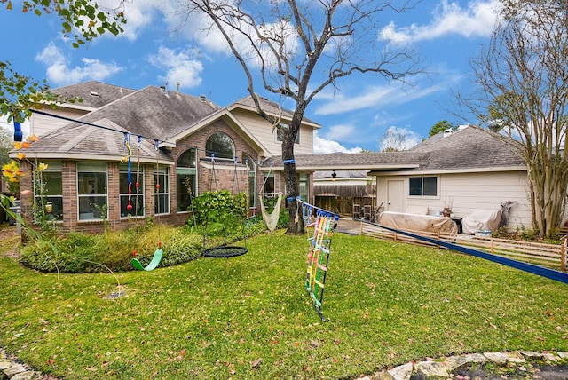 back of property with a lawn and a patio area