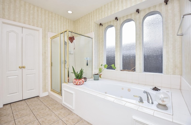 bathroom featuring tile patterned flooring and shower with separate bathtub