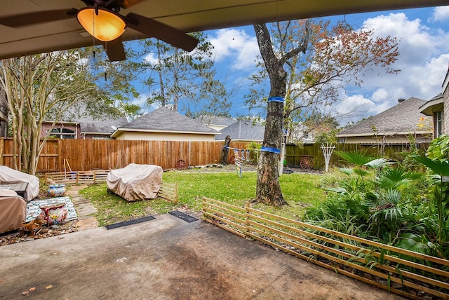 view of yard with a patio area and ceiling fan