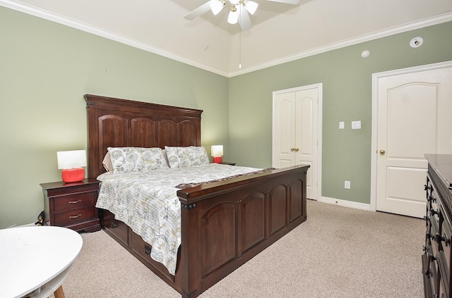 carpeted bedroom with ceiling fan and ornamental molding