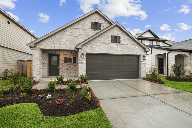 5822 Dawning Sun St, Fulshear, TX 77441 - view of front of home featuring a garage, driveway, and brick siding