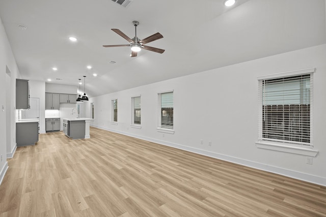 5822 Dawning Sun St, Fulshear, TX 77441 - unfurnished living room with lofted ceiling, baseboards, light wood finished floors, a ceiling fan, and recessed lighting