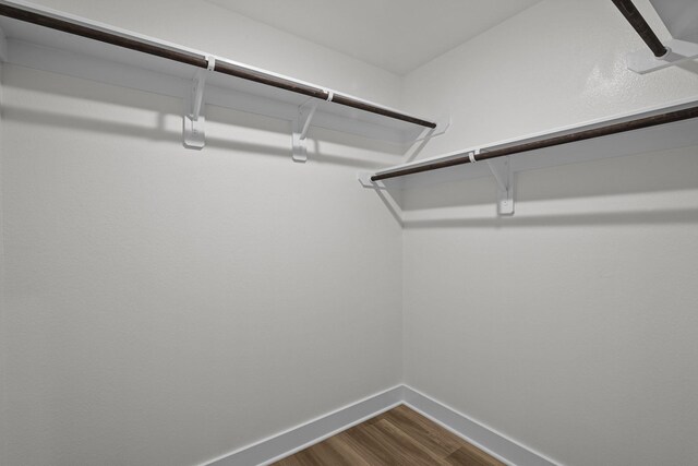 5822 Dawning Sun St, Fulshear, TX 77441 - walk in closet featuring dark wood finished floors