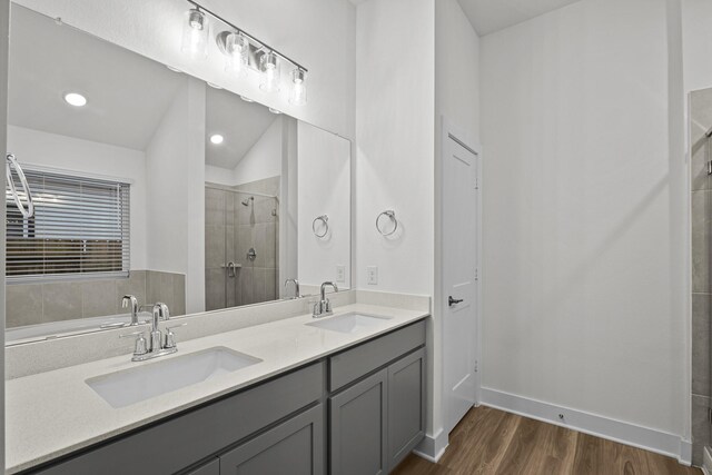 5822 Dawning Sun St, Fulshear, TX 77441 - bathroom with wood finished floors, a tile shower, double vanity, and baseboards