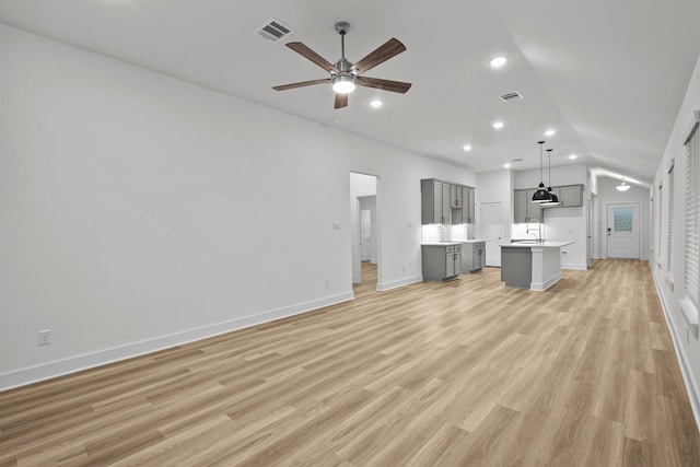 5822 Dawning Sun St, Fulshear, TX 77441 - unfurnished living room with ceiling fan, vaulted ceiling, baseboards, light wood-style floors, and recessed lighting