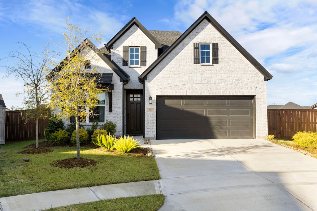 view of front facade with a front lawn and a garage