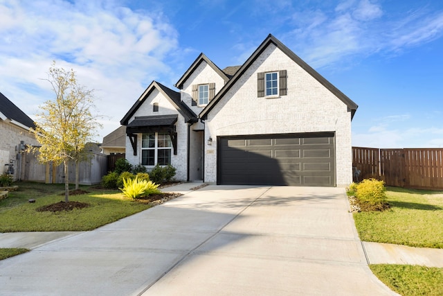 view of front of property with a front lawn and a garage