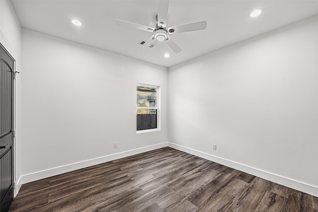 empty room with ceiling fan and dark wood-type flooring