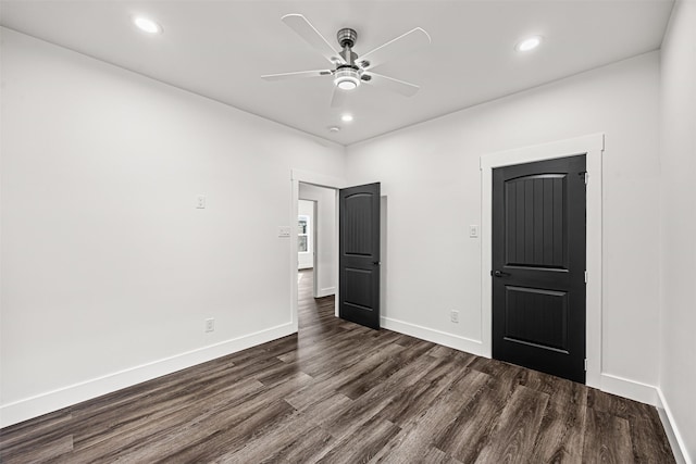 unfurnished bedroom with ceiling fan and dark hardwood / wood-style flooring