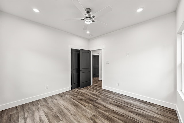 unfurnished bedroom with ceiling fan and hardwood / wood-style floors