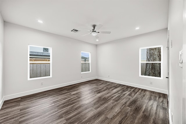 unfurnished room with ceiling fan, a healthy amount of sunlight, and dark hardwood / wood-style floors