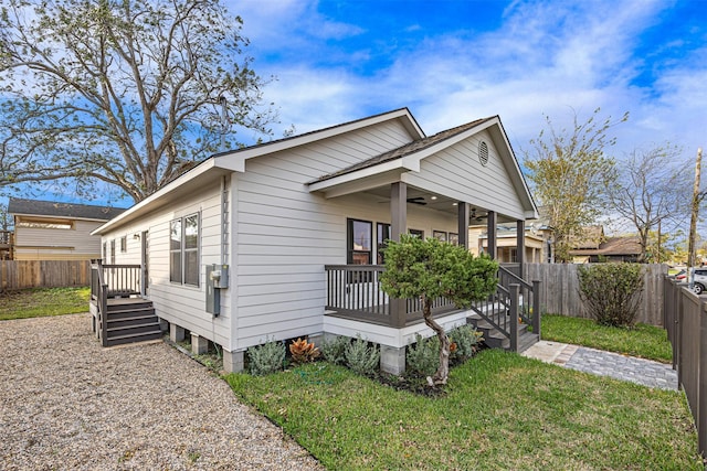 view of front of property with covered porch and a front yard