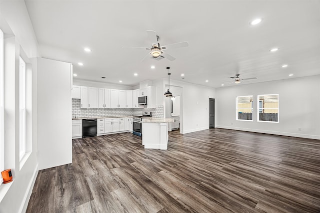 kitchen with white cabinetry, stainless steel range oven, black dishwasher, a kitchen island, and pendant lighting