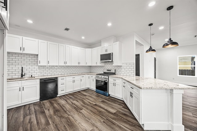 kitchen featuring kitchen peninsula, stainless steel appliances, pendant lighting, and white cabinetry