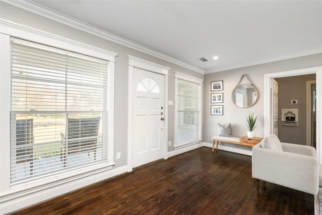 entryway with ornamental molding, plenty of natural light, and dark wood-type flooring