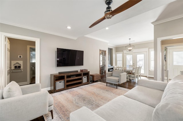 living room featuring french doors, ceiling fan, light hardwood / wood-style floors, and crown molding