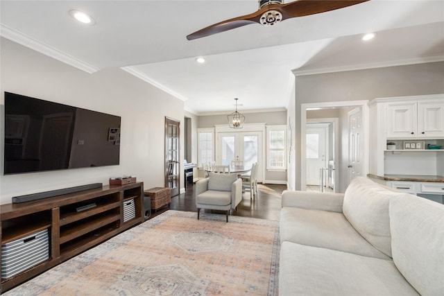 living room featuring ornamental molding, ceiling fan, french doors, and dark hardwood / wood-style floors