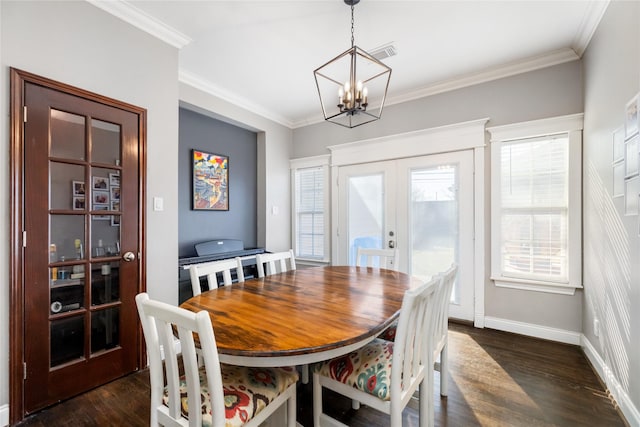 dining space featuring an inviting chandelier, french doors, crown molding, and dark hardwood / wood-style flooring