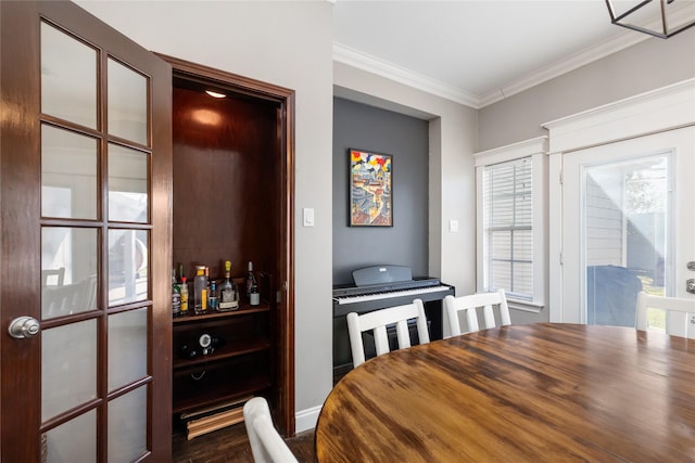 dining space with crown molding