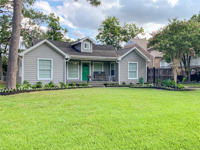 view of front of home with covered porch and a front yard