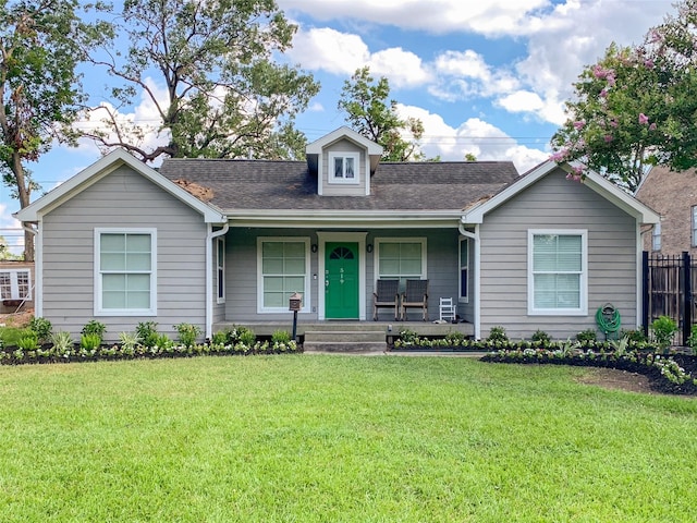 view of front of house with a porch and a front yard