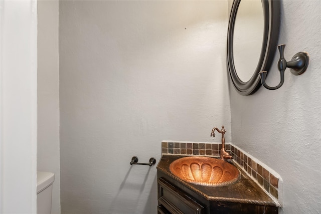 bathroom featuring toilet and vanity