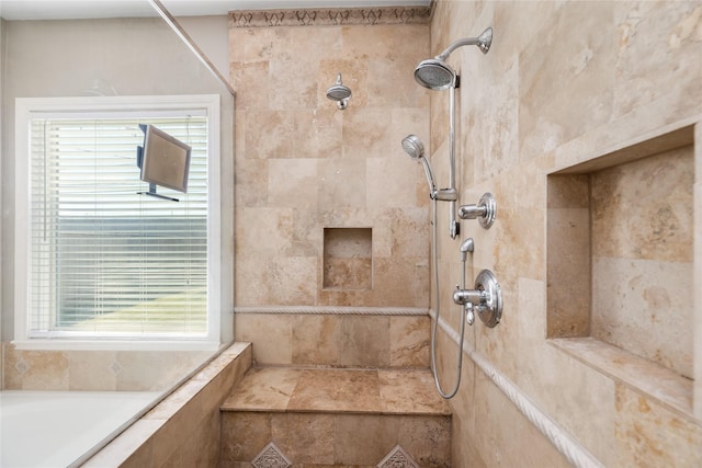 bathroom featuring tiled shower and plenty of natural light