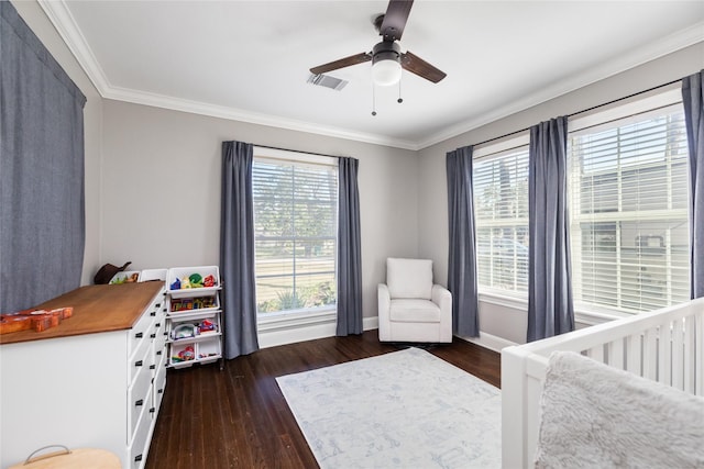 bedroom featuring ceiling fan, dark wood-type flooring, ornamental molding, and a nursery area