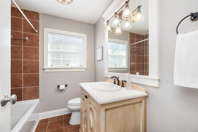 full bathroom with vanity, tiled shower / bath, tile patterned floors, and toilet