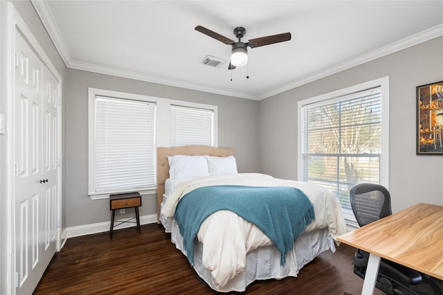 bedroom with ceiling fan, crown molding, a closet, and dark hardwood / wood-style floors