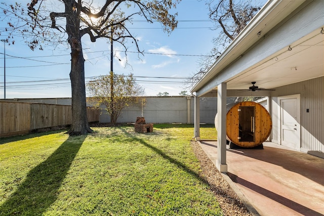 view of yard with ceiling fan and a patio