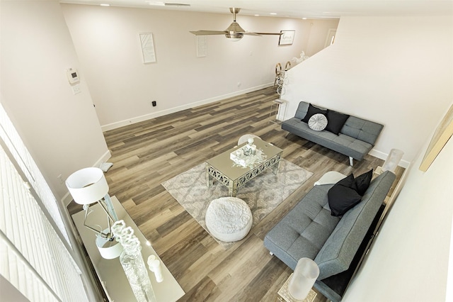 living room featuring ceiling fan and hardwood / wood-style flooring