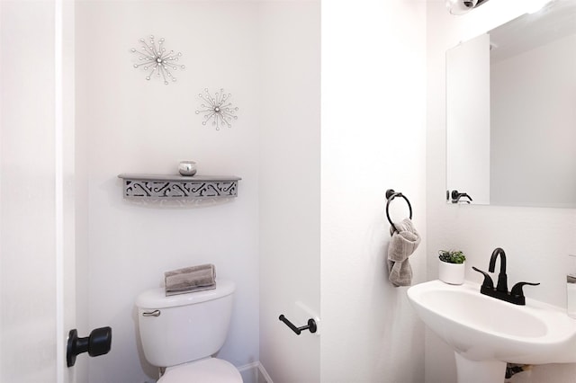 bathroom featuring sink and toilet