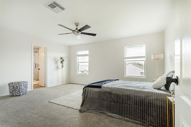 bedroom featuring ensuite bath, carpet floors, and ceiling fan