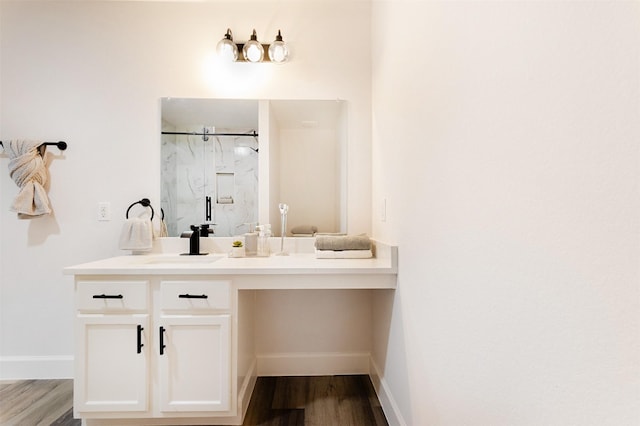 bathroom featuring a shower with door, hardwood / wood-style floors, and vanity