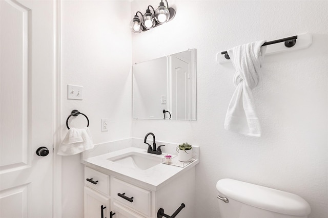 bathroom featuring toilet and vanity