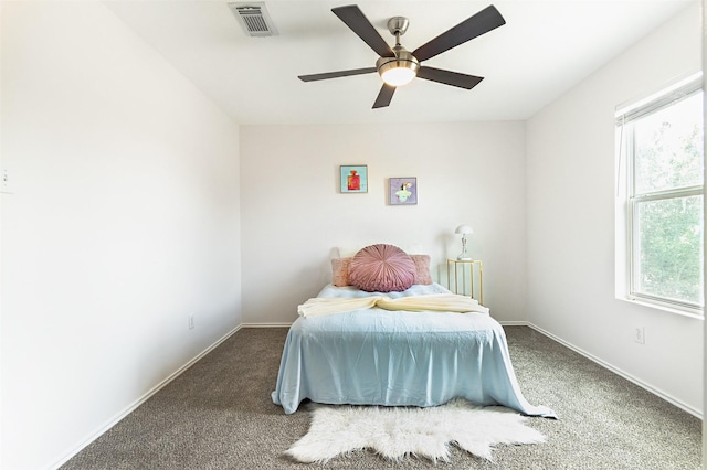 bedroom with ceiling fan, carpet flooring, and multiple windows