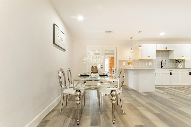 dining space with light wood-type flooring