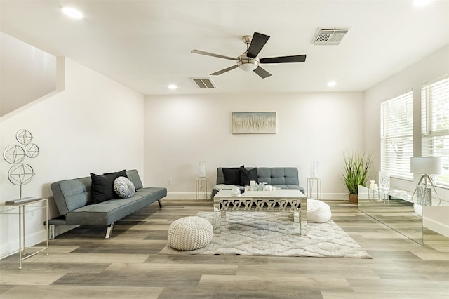 living room with hardwood / wood-style floors and ceiling fan