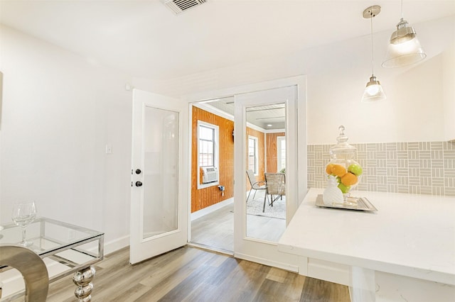 entryway featuring french doors, wood-type flooring, and cooling unit