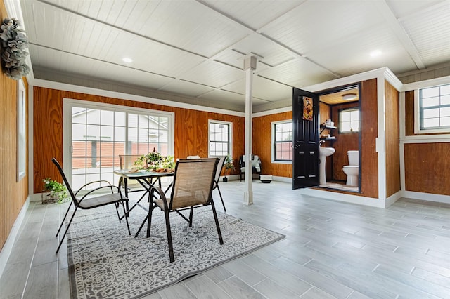 dining space featuring wood walls