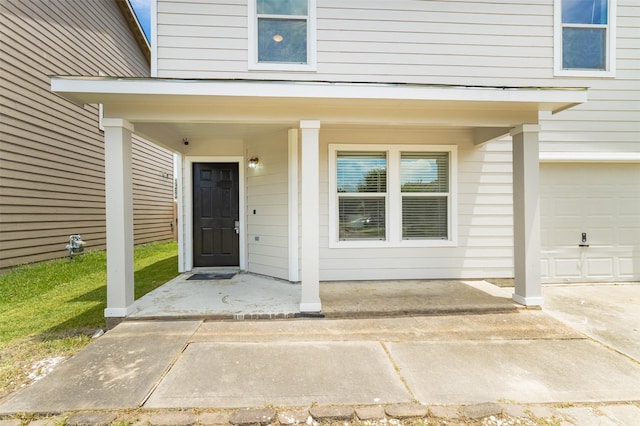 view of exterior entry with a garage