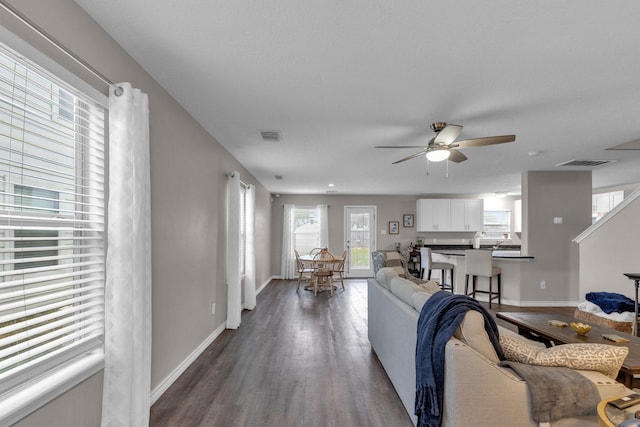 living room featuring ceiling fan and wood-type flooring