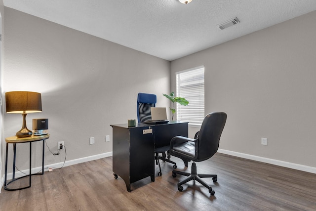 office space featuring a textured ceiling and wood-type flooring