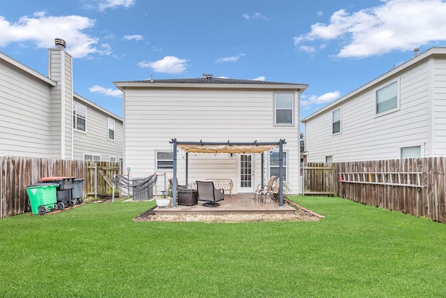 rear view of property with a patio, a yard, and a pergola