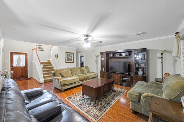 living room featuring ceiling fan, crown molding, and hardwood / wood-style flooring