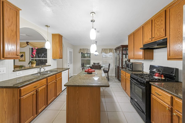 kitchen featuring hanging light fixtures, a center island, white dishwasher, sink, and black gas stove