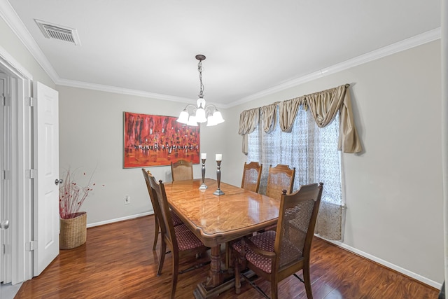 dining room featuring dark hardwood / wood-style flooring, an inviting chandelier, and ornamental molding